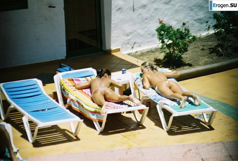 Girls sunbathe topless near the pool. Photo 16