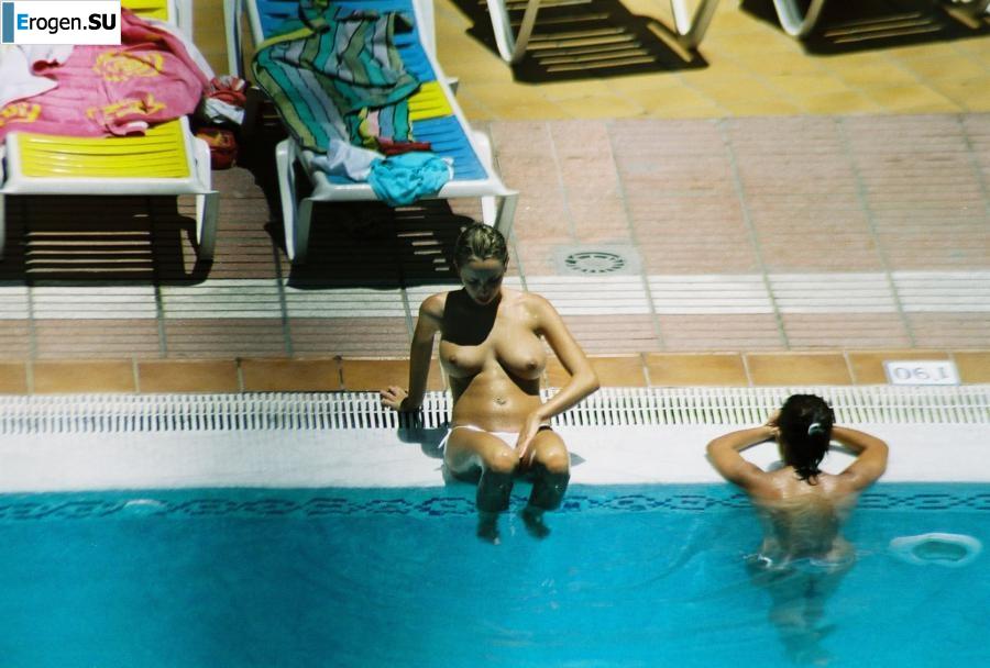 Girls sunbathe topless near the pool. Photo 18