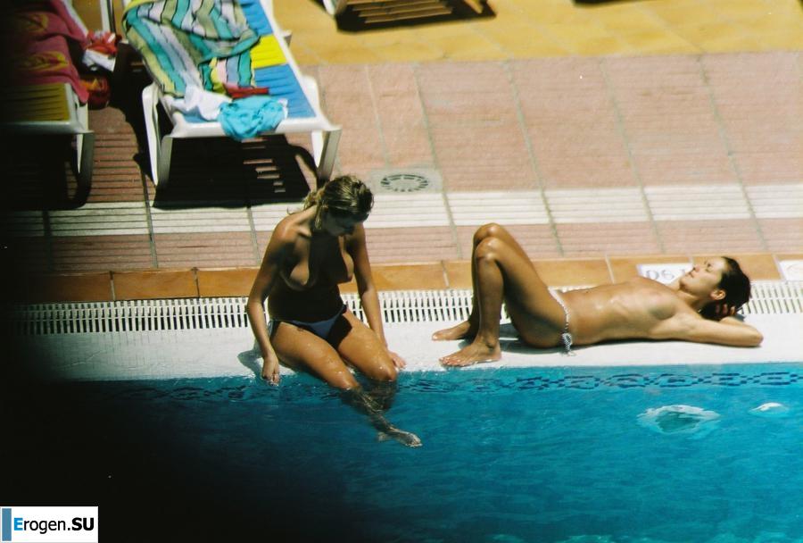 Girls sunbathe topless near the pool. Photo 19
