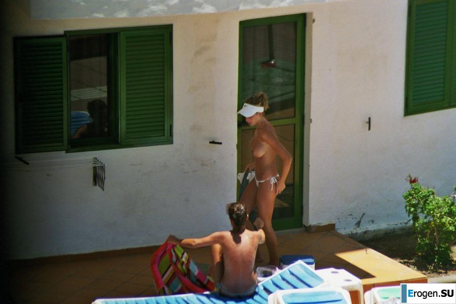 Girls sunbathe topless near the pool. Photo 32