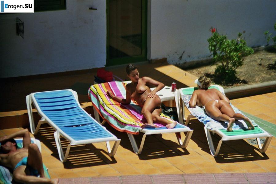 Girls sunbathe topless near the pool. Photo 38