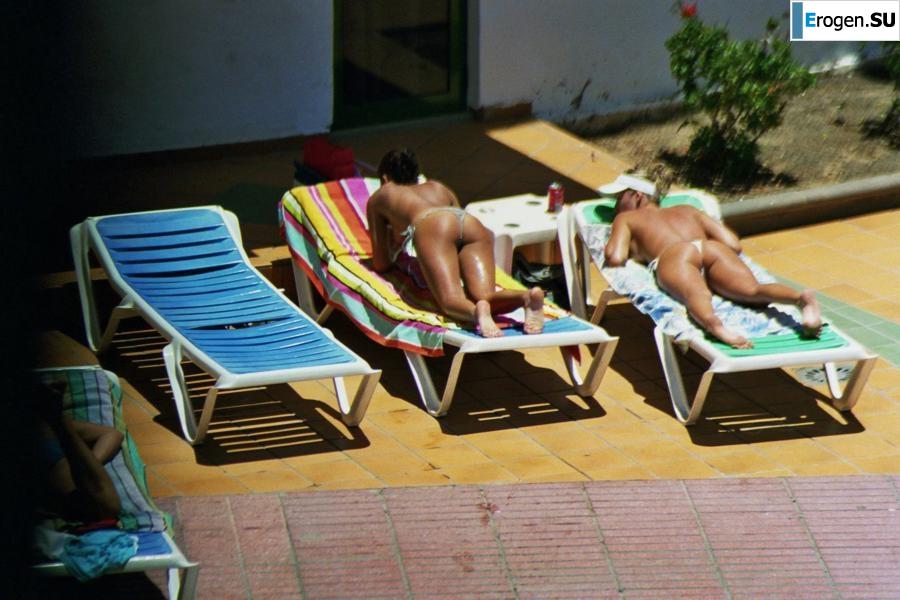 Girls sunbathe topless near the pool. Photo 40