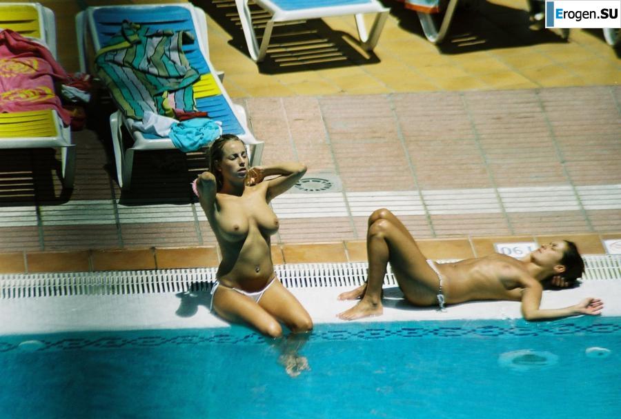 Girls sunbathe topless near the pool. Photo 6