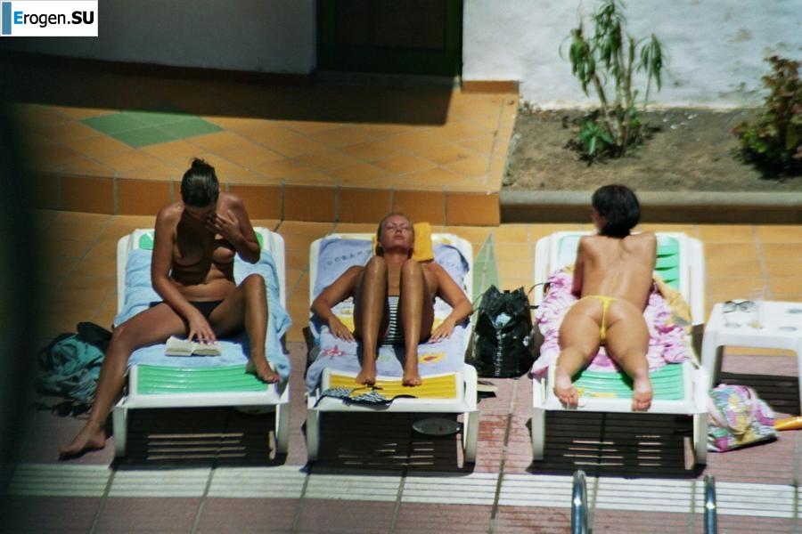 Girls sunbathe topless near the pool. Part 3. Photo 14