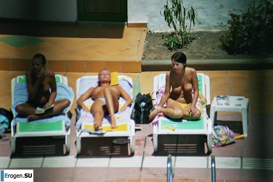 Girls sunbathe topless near the pool. Part 3. Photo 18