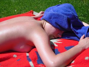three girlfriends sunbathe in the yard with bare breasts. Thumb 12