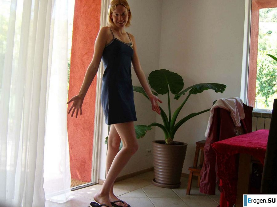 A tanned blonde with lingerie marks poses for a friend. Slide 5