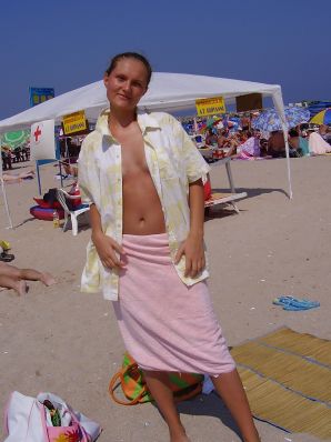 Sexy girl posing on the beach in shorts without a bra. Thumb 13
