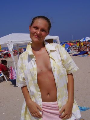 Sexy girl posing on the beach in shorts without a bra. Thumb 14