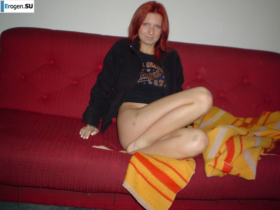 The red-haired beauty with a shaved pussy poses in one jacket. Slide 14