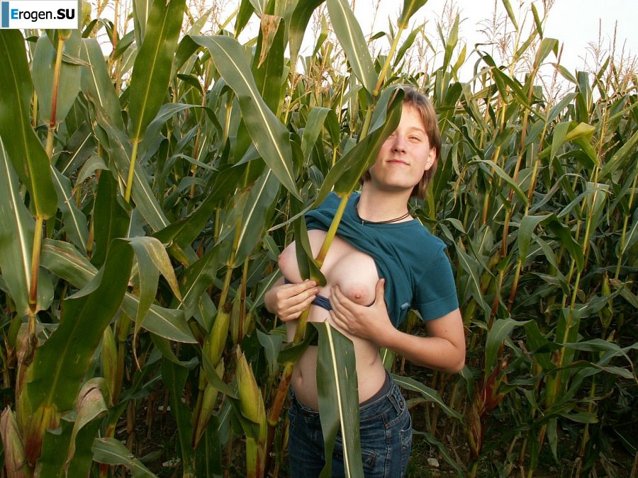 A thin student pleases herself with corn right in the field. Photo 5