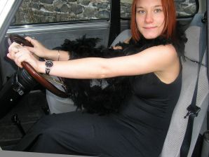 A redhead girl in fishnet tights undresses right on the street. Thumb 8