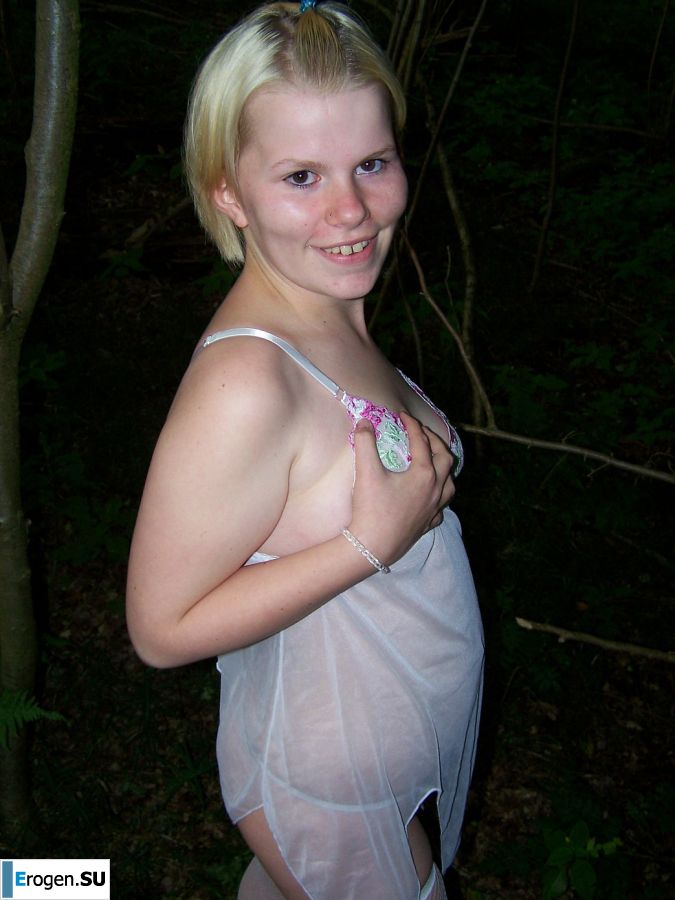 Appetizing magnificent blonde spread her legs right on the grass. Slide 13