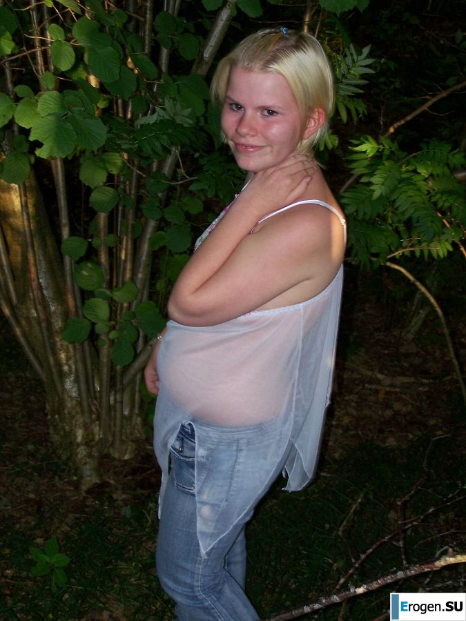 Appetizing magnificent blonde spread her legs right on the grass. Slide 2